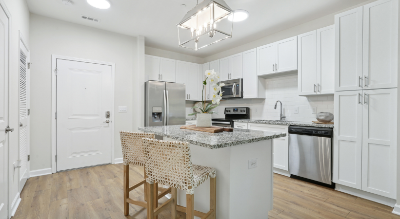 Renovated kitchen with white cabinets,  and stainless steel appliances
