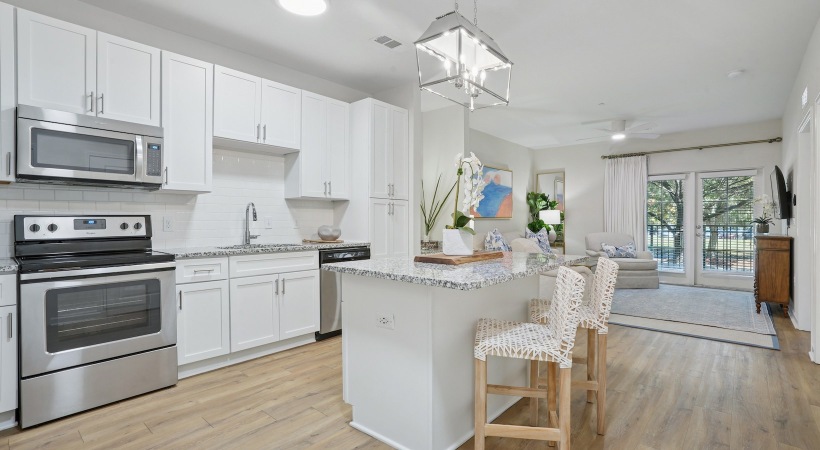 Renovated  kitchen with white cabinets,  and stainless steel appliances