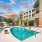 pool area with reclining seats and landscaping