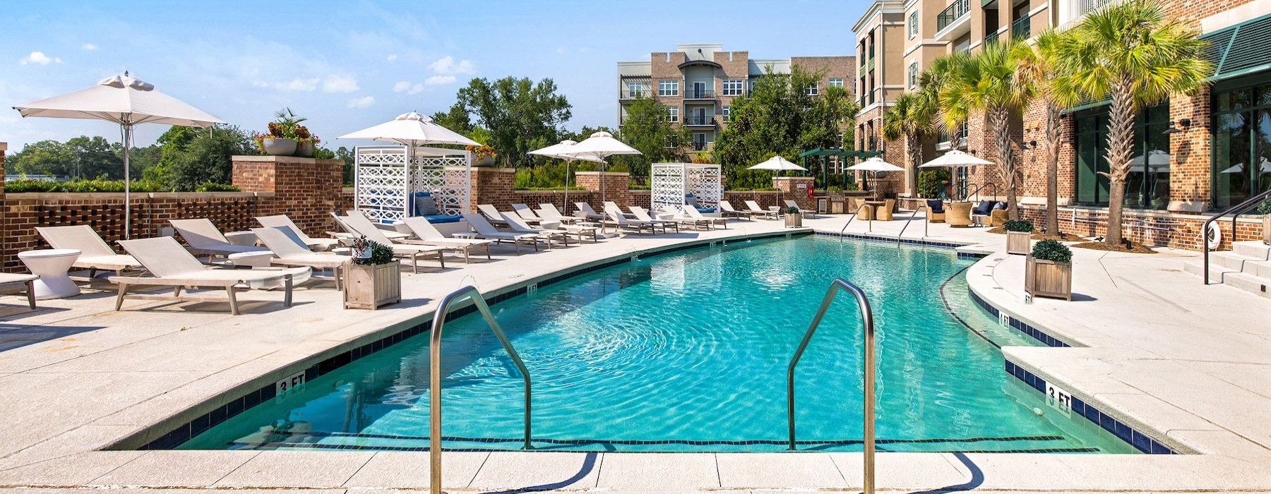 pool showing reclining seating and nearness to property buildings