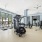 fitness center in a bright well-lit room showing plenty of equipment and modern decor in a large, spacious room